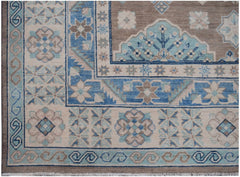 Handmade Afghan Kazakh rug featuring geometric floral patterns in shades of blue, beige, and grey.