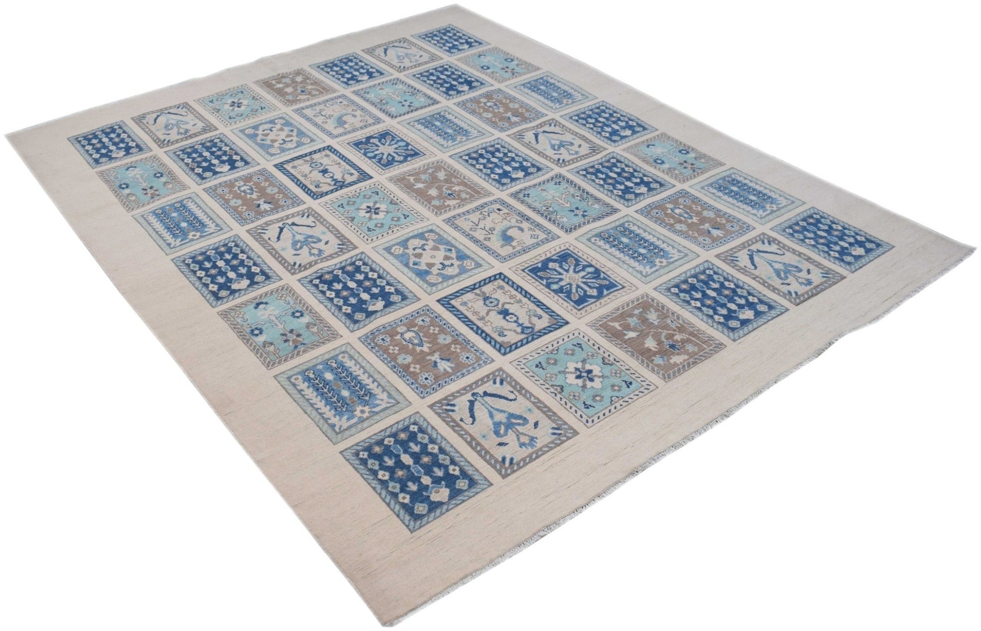 Handmade Afghan Kazakh rug featuring a grid of blue and beige geometric floral patterns.