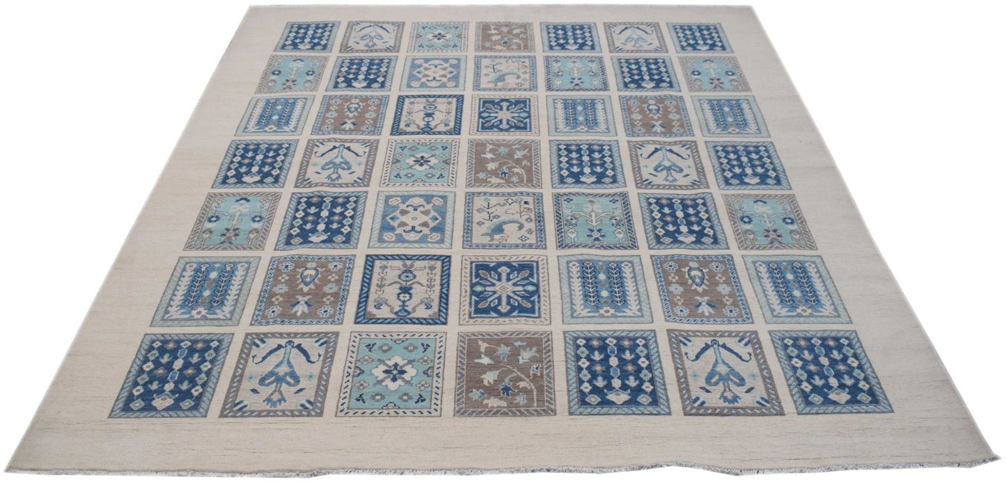 A handmade Afghan Kazakh rug featuring a grid of blue and beige patterned squares on a light base.