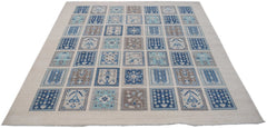 A handmade Afghan Kazakh rug featuring a grid of blue and beige patterned squares on a light base.