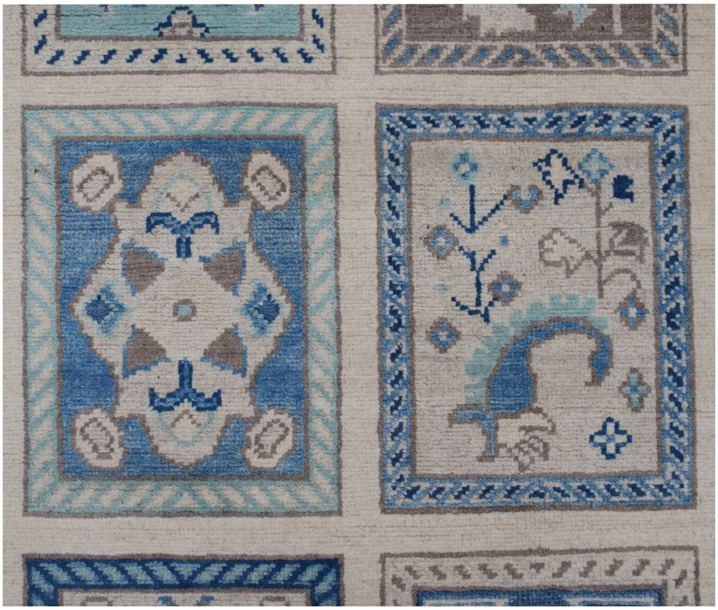 Handmade Afghan Kazakh rug featuring a grid of rectangular panels with blue and beige floral motifs.