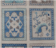 Handmade Afghan Kazakh rug featuring a grid of rectangular panels with blue and beige floral motifs.
