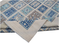 Handmade Afghan Kazakh rug featuring a geometric patchwork design in shades of blue and beige.
