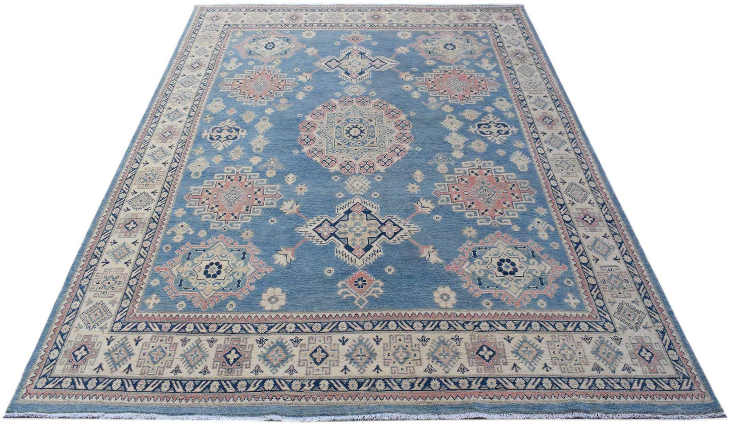 A handmade Afghan Kazakh rug featuring traditional geometric motifs in blue, pink, and cream.