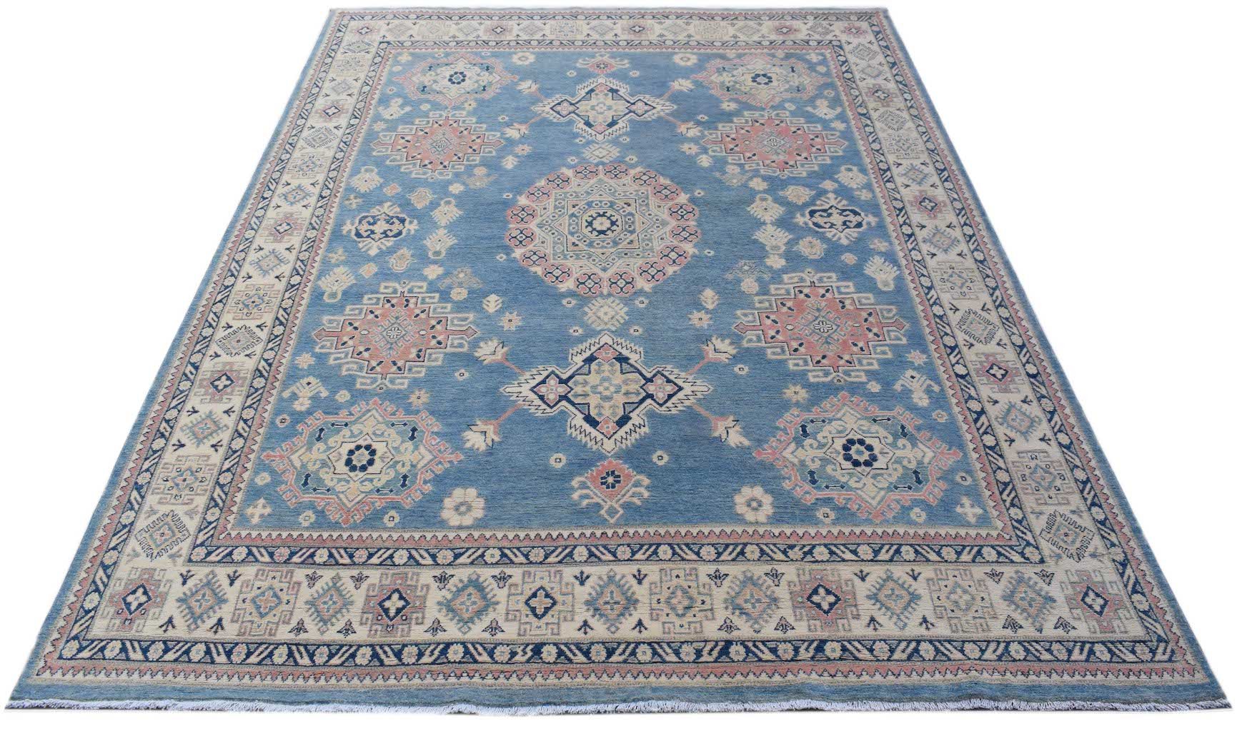 A handmade Afghan Kazakh rug featuring traditional geometric motifs in blue, pink, and cream.