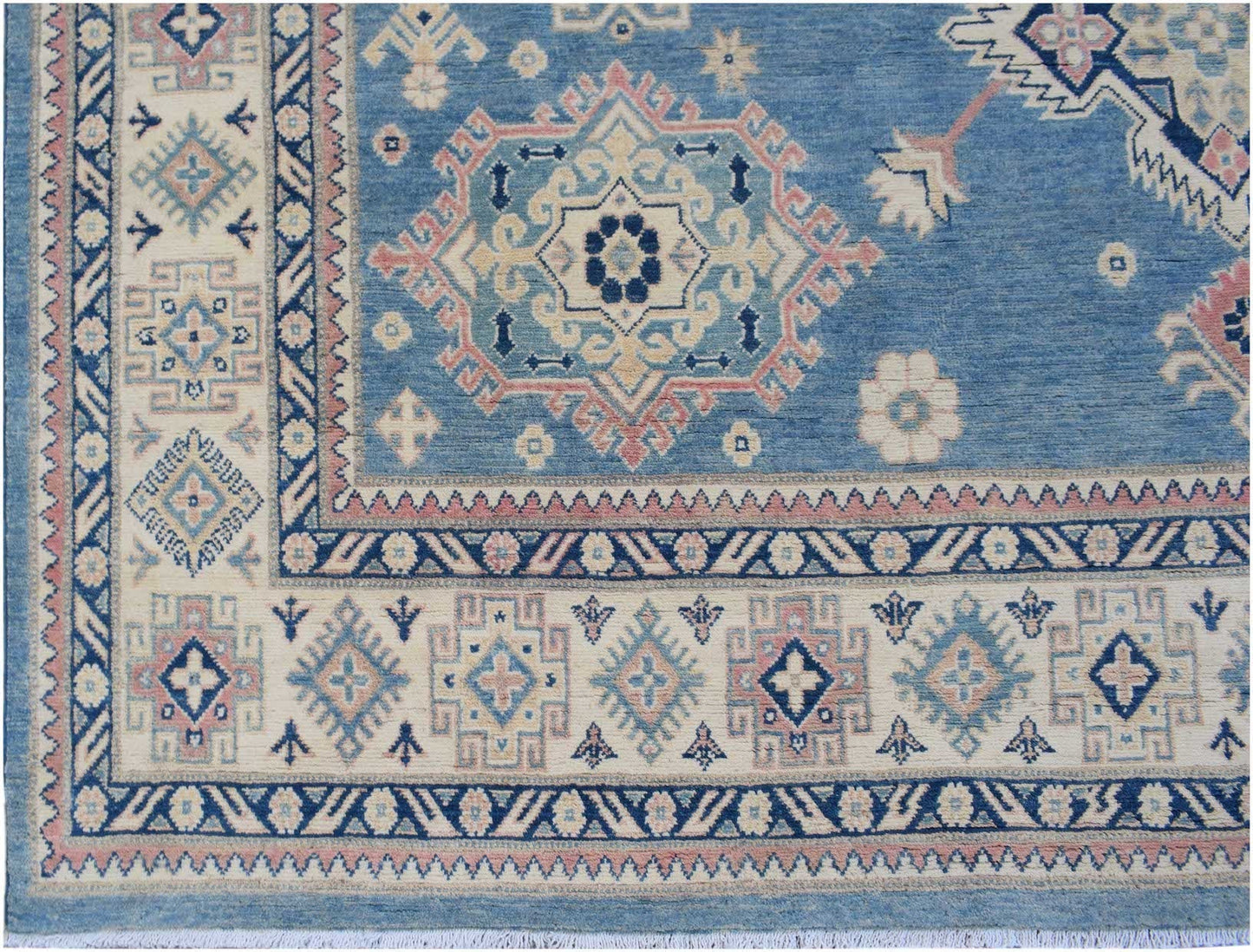 Handmade Afghan Kazakh rug featuring traditional geometric motifs in blue, cream, and pink wool.