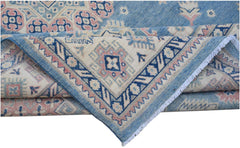 A handmade Afghan Kazakh rug featuring traditional geometric motifs in blue, pink, and cream.