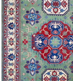 Handmade Afghan Kazakh rug featuring a geometric pattern in red, blue, and green on a wool pile.