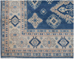 Handmade Afghan Kazakh rug featuring a blue field with beige geometric patterns and a wide border.