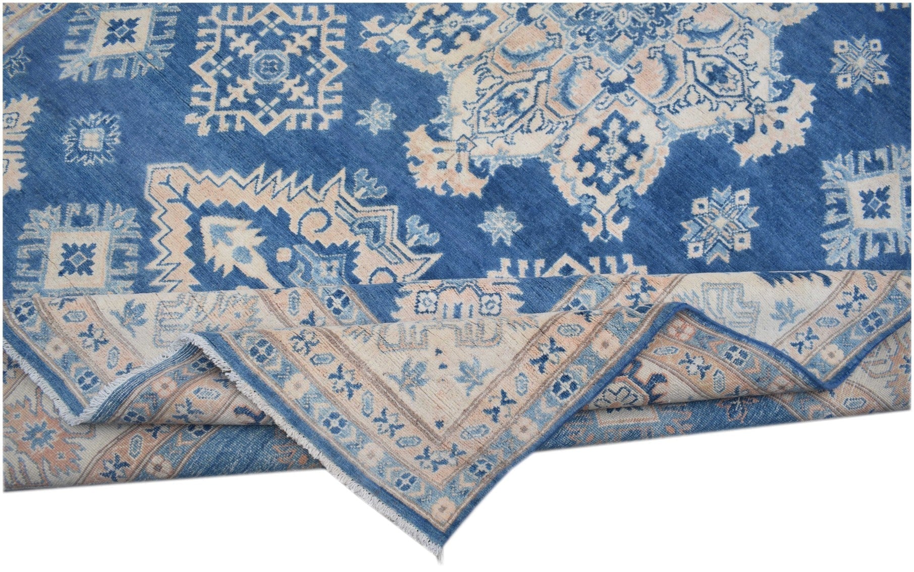 A handmade Afghan Kazakh rug featuring a blue field with beige geometric patterns and a folded edge.