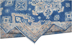 A handmade Afghan Kazakh rug featuring a blue field with beige geometric patterns and a folded edge.