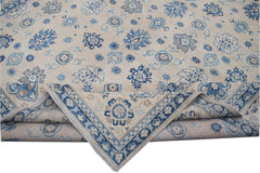 Handmade Afghan Kazakh wool rug featuring a beige field with blue and grey floral motifs.