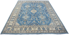 An Afghan Kazakh rug featuring a blue field with intricate beige and grey geometric patterns.