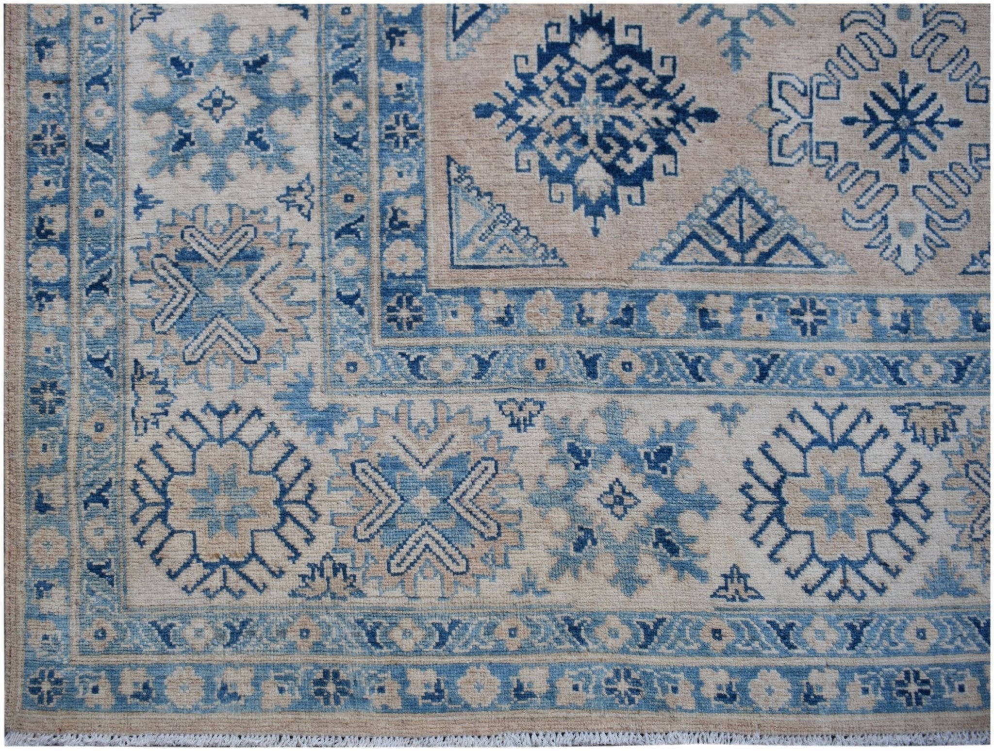 Handmade Afghan Kazakh rug featuring traditional blue and beige geometric patterns.