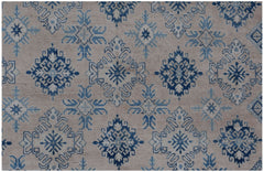 Handmade Afghan Kazakh rug featuring a repeating blue and cream geometric snowflake pattern.