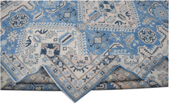 Handmade Afghan Kazakh wool rug featuring a geometric pattern in shades of blue, beige, and grey.