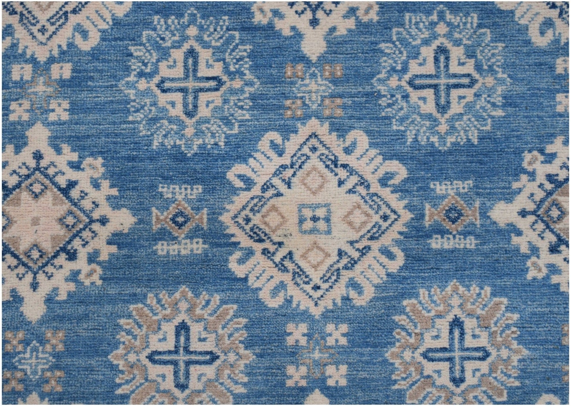Handmade Afghan Kazakh rug featuring a geometric pattern in shades of blue, beige, and grey.