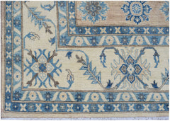 A handmade Afghan Kazakh rug featuring traditional blue and beige floral patterns.