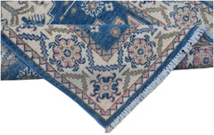 A handmade Afghan Kazakh runner featuring traditional blue, pink, and cream geometric patterns.