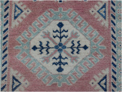 Handmade Afghan Kazakh runner featuring a central floral medallion in blue, pink, and cream wool.