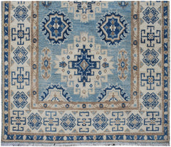 Handmade Afghan Kazakh runner rug featuring geometric blue and beige tribal patterns.
