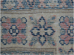 A close-up of a handmade Afghan Kazakh runner featuring traditional geometric motifs in wool.
