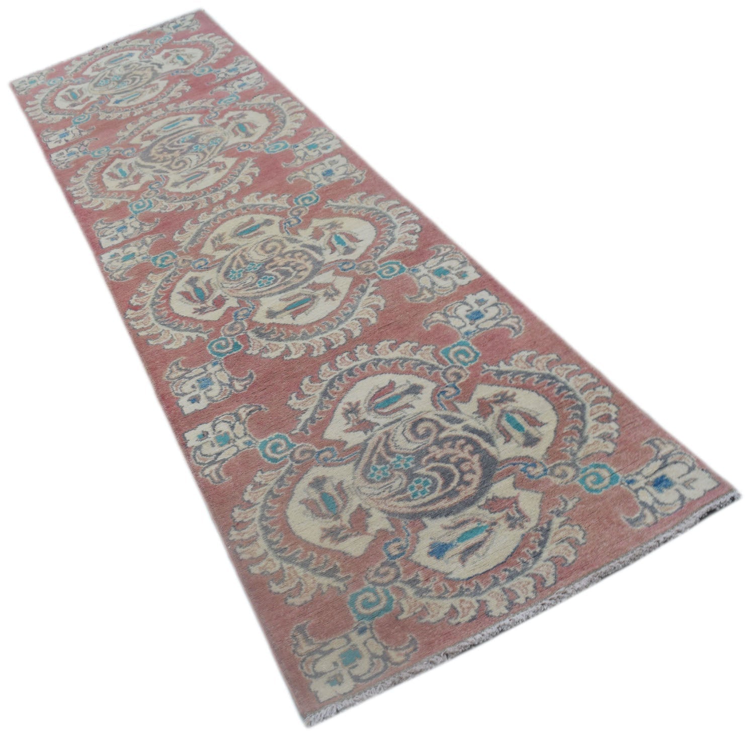 A handmade Afghan Kazakh runner rug featuring traditional motifs in pink, cream, and blue tones.