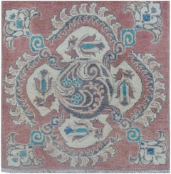 A handmade Afghan Kazakh runner featuring traditional floral motifs in pink, cream, and blue.