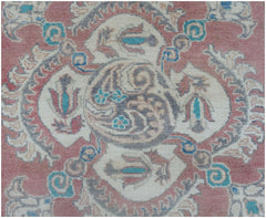 A handmade Afghan Kazakh runner featuring traditional floral motifs in pink, blue, and cream.