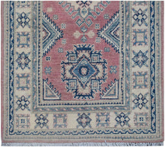 Handmade Afghan Kazakh runner rug featuring traditional geometric motifs in pink, blue, and cream.