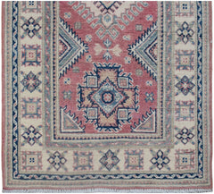 Handmade Afghan Kazakh runner rug featuring traditional geometric motifs in pink, blue, and cream.