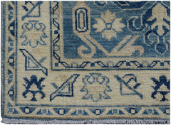 Handmade Afghan Kazakh runner rug featuring a blue and beige geometric pattern.