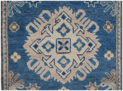 Handmade Afghan Kazakh runner featuring a central geometric medallion in beige and blue wool.