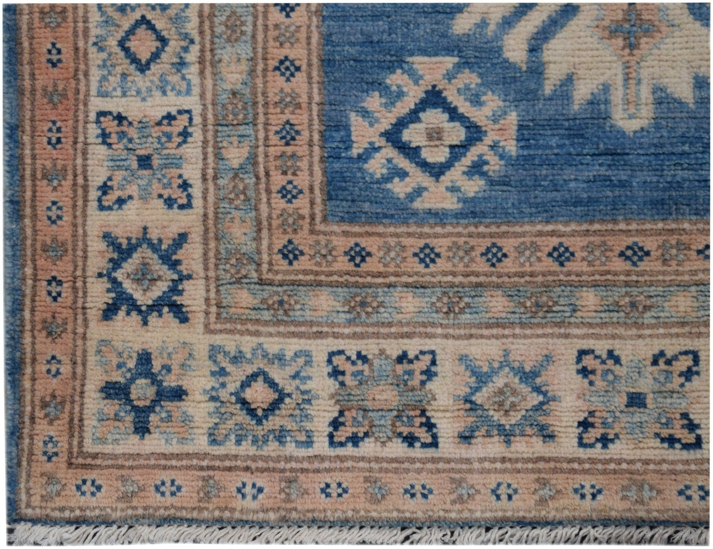 Handmade Afghan Kazakh runner rug featuring geometric patterns in shades of blue, beige, and grey.
