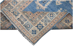 Handmade Afghan Kazakh runner rug featuring a blue field with beige and grey geometric patterns.