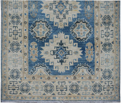Handmade Afghan Kazakh runner rug featuring geometric patterns in shades of blue, beige, and grey.