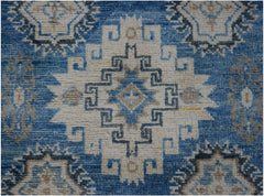Handmade Afghan Kazakh runner rug featuring a geometric medallion pattern in blue and beige.
