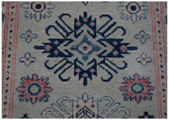 Handmade Afghan Kazakh runner rug featuring traditional blue and pink geometric floral motifs.