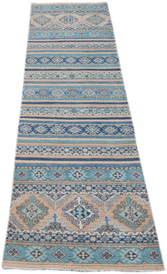 A handmade Afghan Kazakh runner rug featuring geometric patterns in shades of blue and beige.