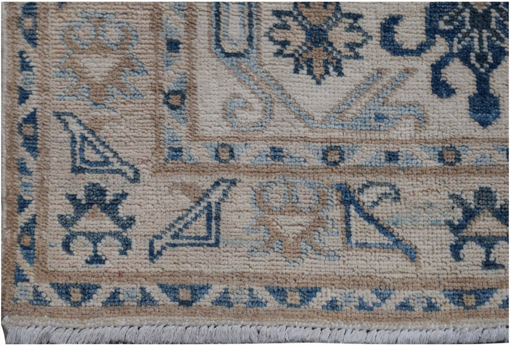 A handmade Afghan Kazakh runner featuring traditional blue and beige geometric patterns.