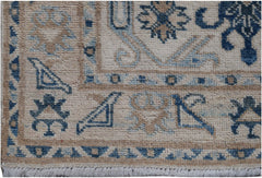 A handmade Afghan Kazakh runner featuring traditional blue and beige geometric patterns.