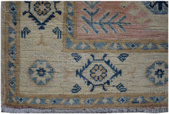 Handmade Afghan Kazakh runner featuring geometric blue and beige patterns on a wool pile.