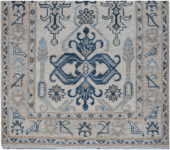 Handmade Afghan Kazakh runner featuring a traditional blue and beige geometric pattern.