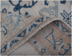 A handmade Afghan Kazakh runner featuring traditional blue and beige geometric patterns.
