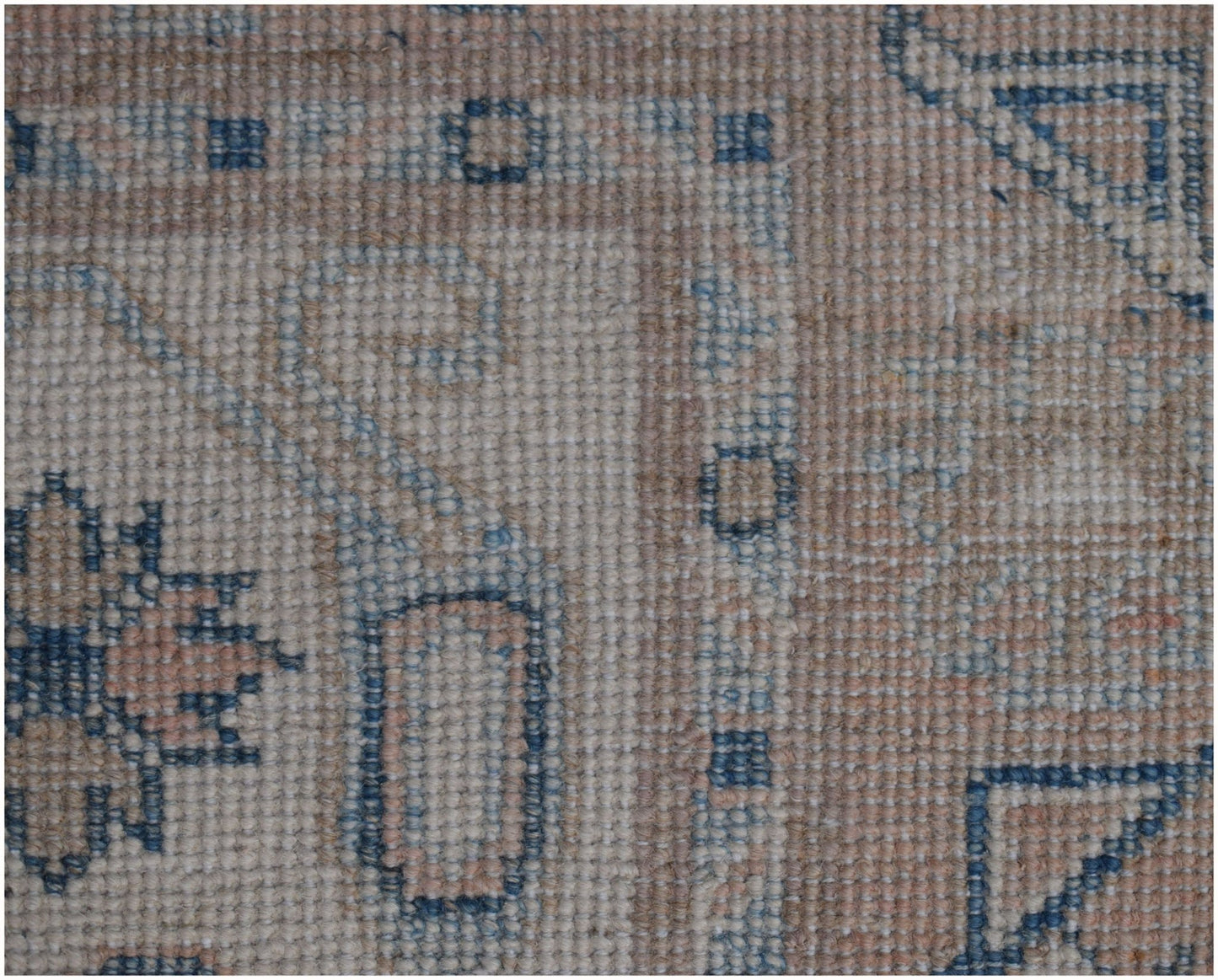 A close-up of a handmade Afghan Kazakh runner featuring traditional geometric patterns in wool.
