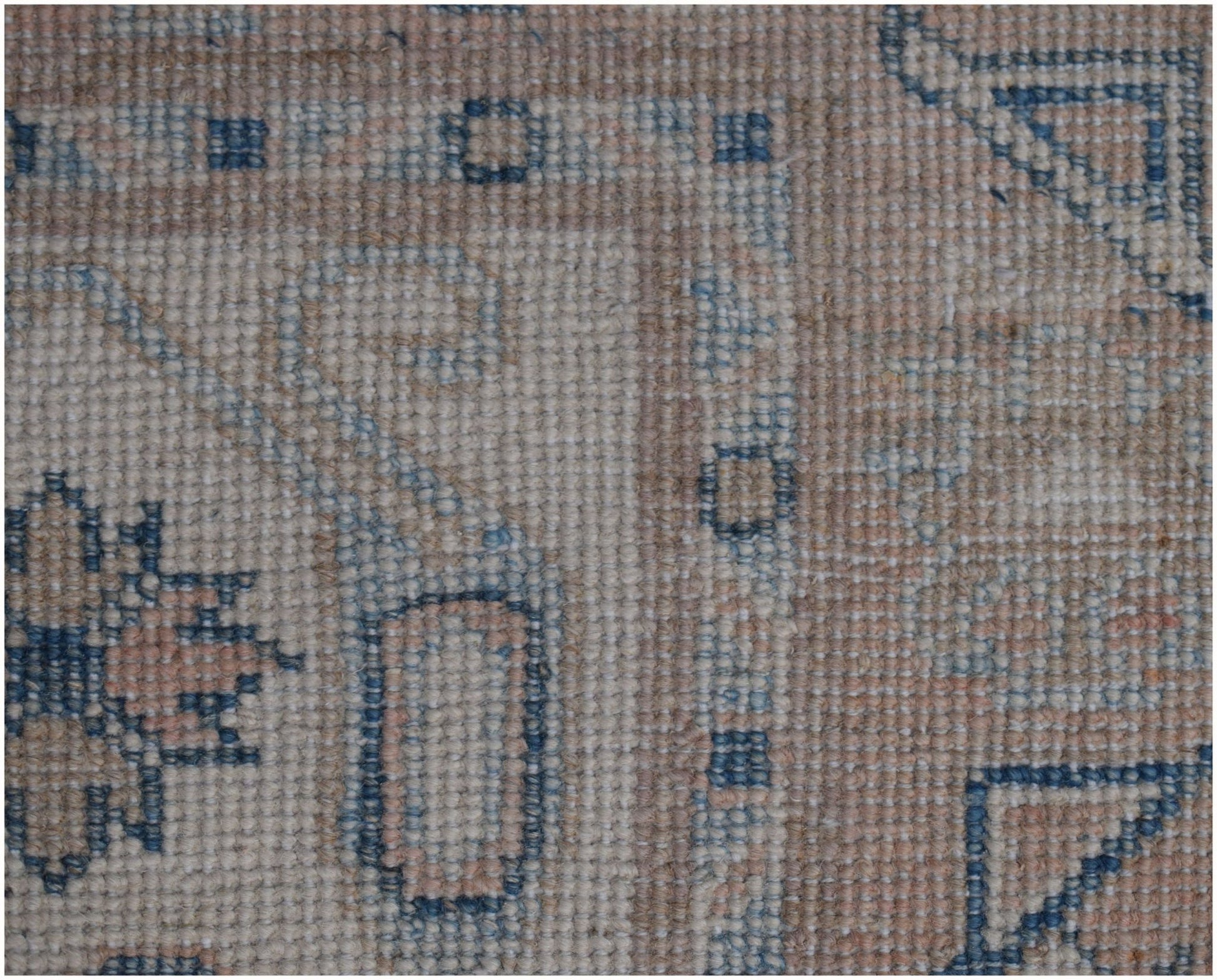 A close-up of a handmade Afghan Kazakh runner featuring traditional geometric patterns in wool.