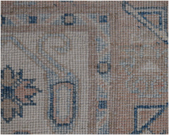 A close-up of a handmade Afghan Kazakh runner featuring traditional geometric patterns in wool.