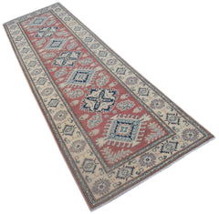 A handmade Afghan Kazakh runner rug featuring traditional geometric motifs in red, blue, and cream.