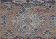 Handmade Afghan Kazakh runner rug featuring a geometric diamond medallion in blue and cream tones.
