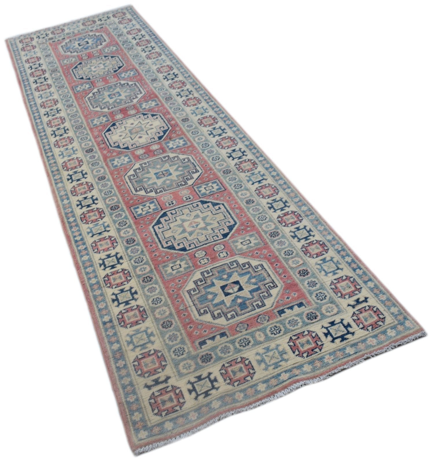 A handmade Afghan Kazakh runner rug featuring traditional geometric motifs in pink and blue.